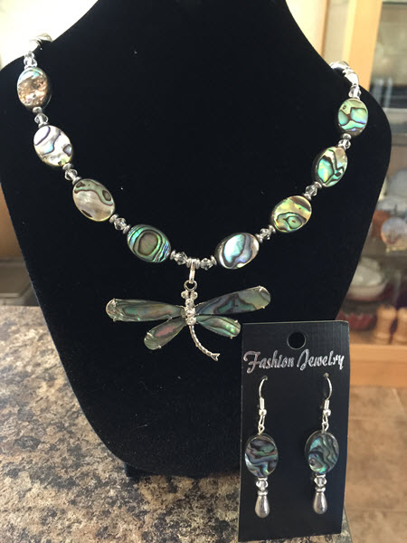 Abalone Dragonfly pendant on necklace of oval abalone beads connected to Hematite beads